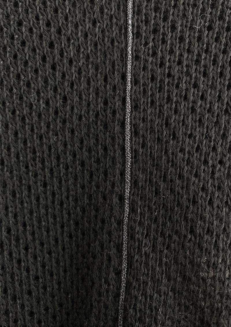 Closeup of a black knit Cocoon nursing cover showing breathable texture of knit and metallic black piping