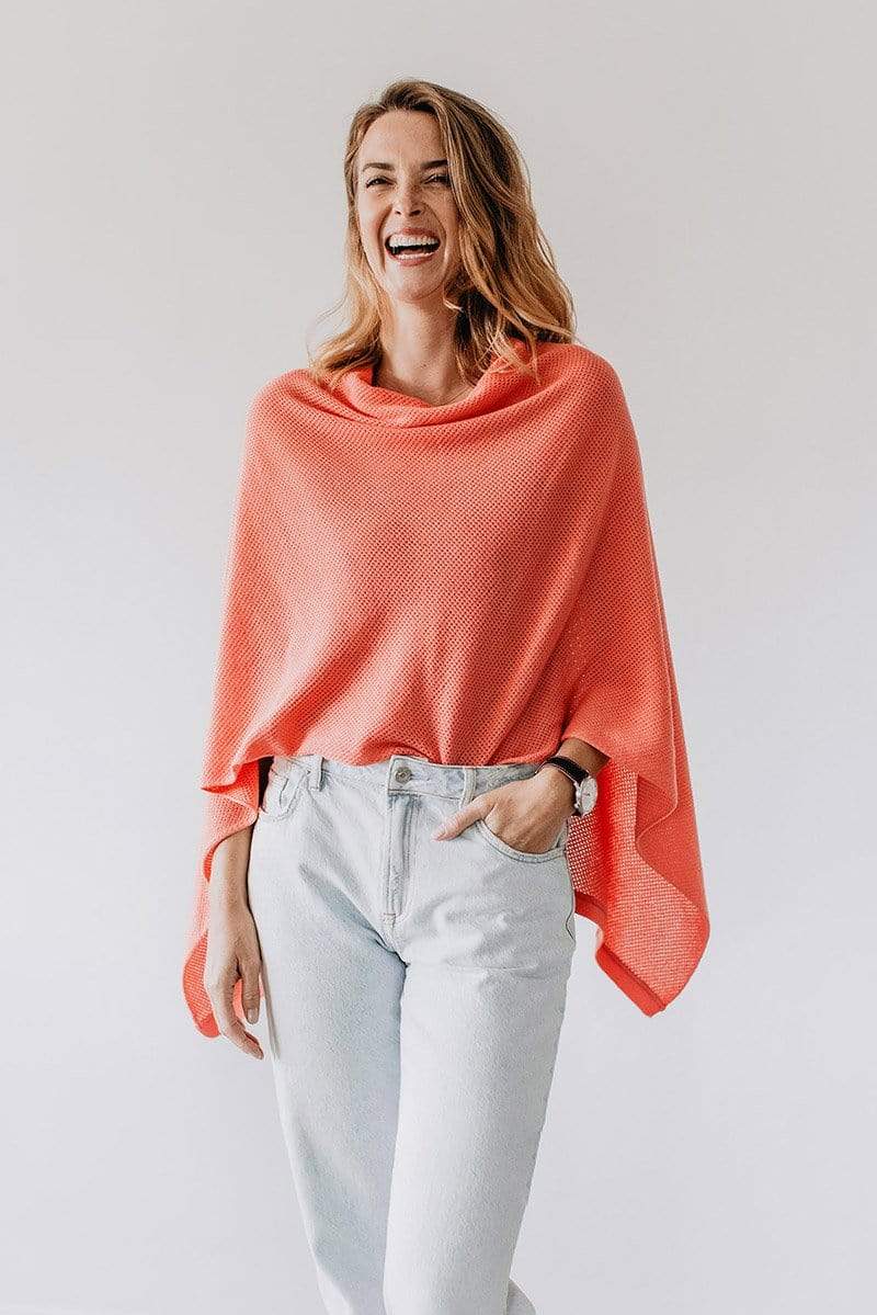 Emily Baldoni wearing coral knit Cocoon nursing cover styled as cape