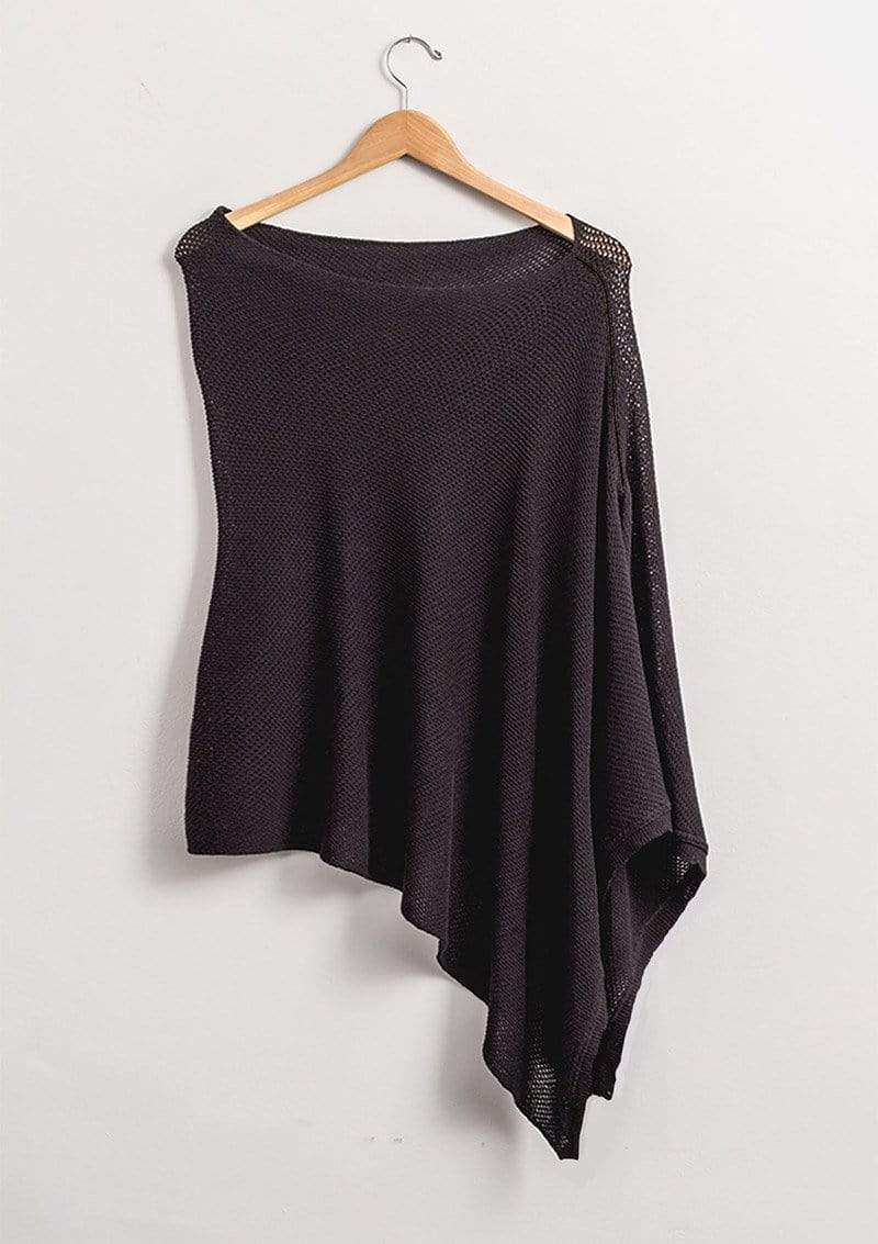 black knit Cocoon nursing poncho hanging on wooden hanger against white background